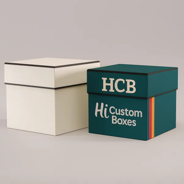 Two square rigid gift boxes one plain white with black trim one branded with HCB and colourful stripes class=