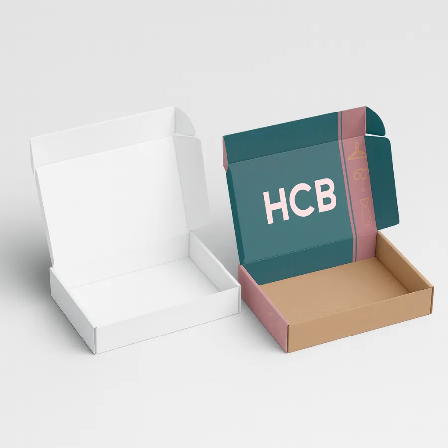 Two open mailer-style shirt boxes- one plain white and the other printed with teal and pink design featuring -HCB- branding- showcasing interior space for folded apparel-