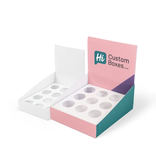 Two display-style boxes with circular insert cutouts- one plain white and one in pink- teal- and purple with Hi Custom Boxes branding on raised back panel- class=