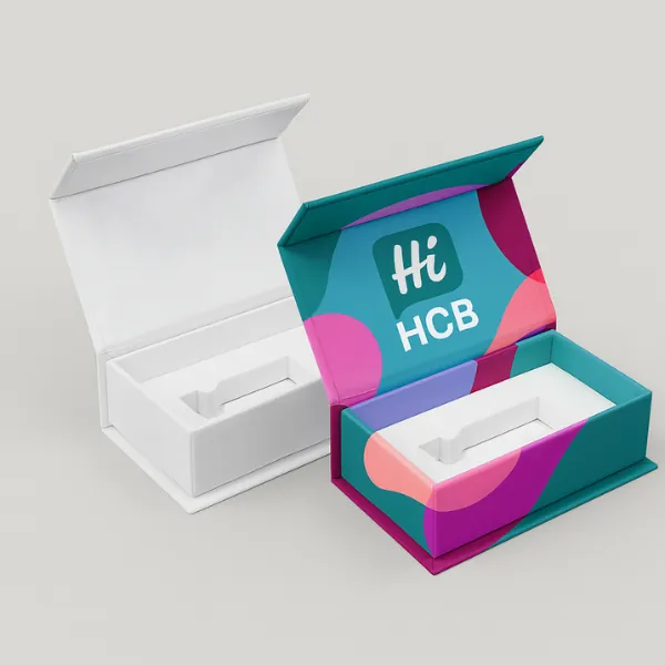 Magnetic closure rigid boxes with inserts- one plain white and one custom-printed with the HCB logo and colorful abstract patterns- class=
