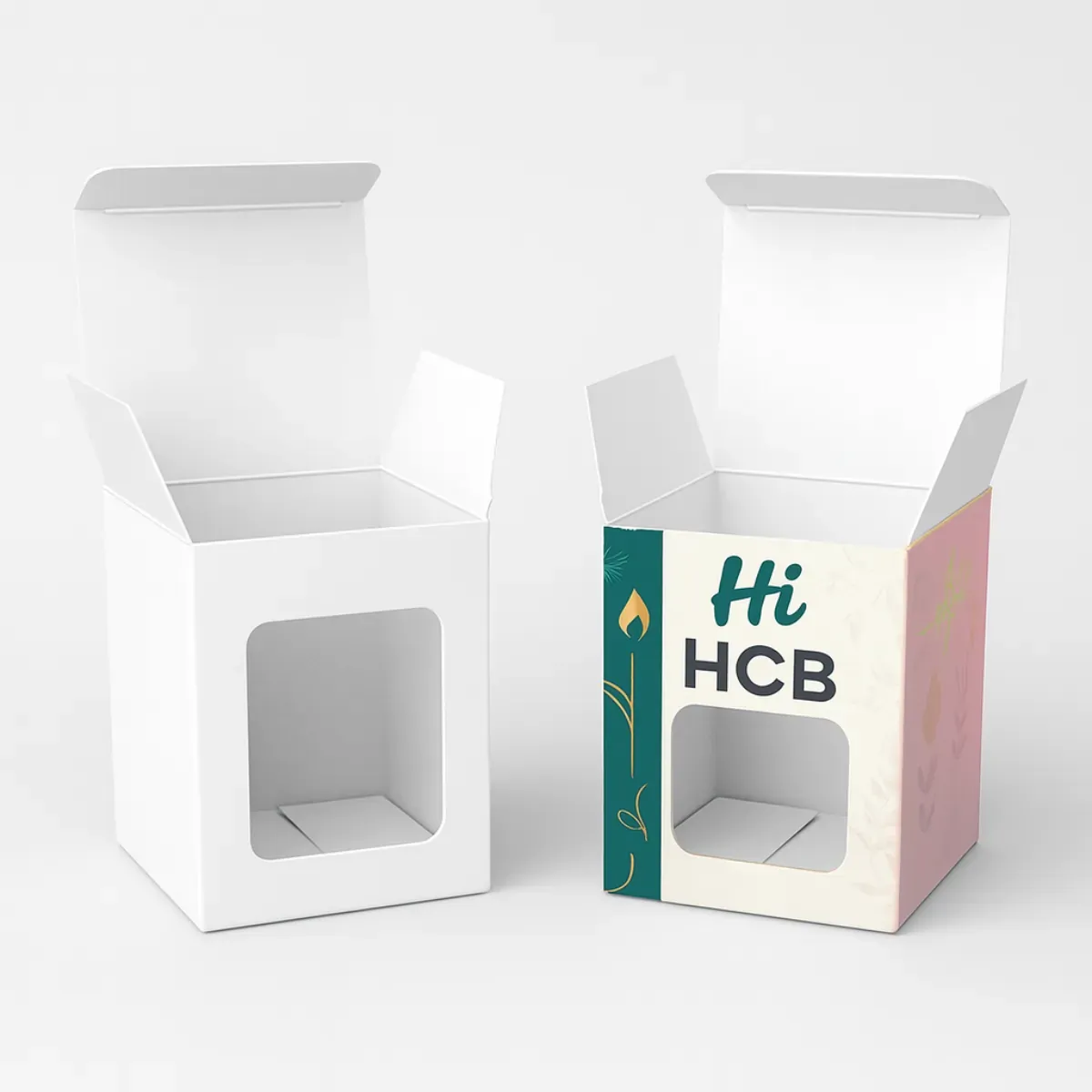 Two open rectangular packaging boxes with tuck tops and clear front windows- One is plain white- while the designed version has teal and pink accents with -Hi HCB- branding and a flame motif class=