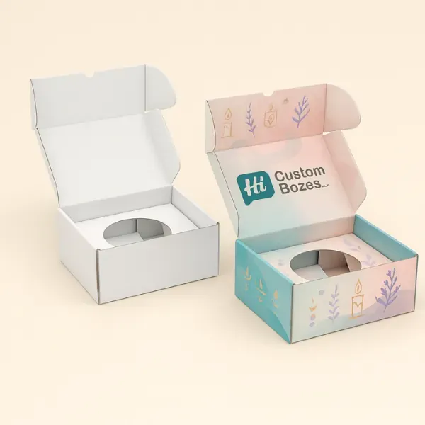 Two open custom tuck-top boxes with inserts- one plain white and one pastel-printed with branding and candle-themed illustrations class=