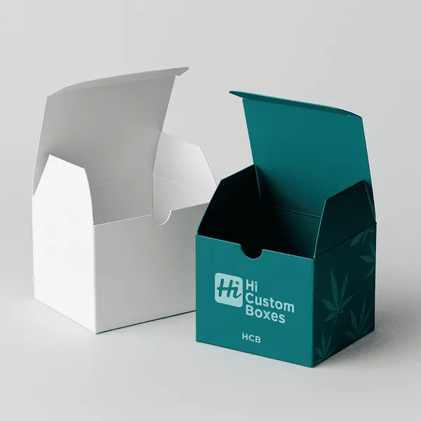 Open CBD boxes in white and teal with HCB branding on soft grey backdrop class=