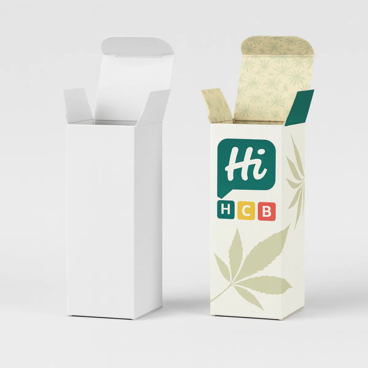Two rectangular tuck-end packaging boxes- one plain white and the other custom printed with a green and beige design- hemp leaf illustrations- and Hi HCB branding- Both boxes are open at the top- class=