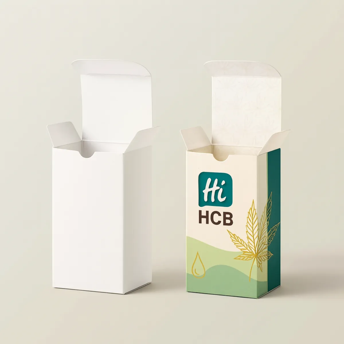 Two tall rectangular packaging boxes- one plain white and the other custom printed with a green and beige design- leaf pattern- and Hi HCB branding- Both boxes are open at the top--