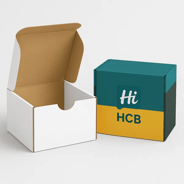 White and teal CBD boxes with HCB logo open on a light grey background class=