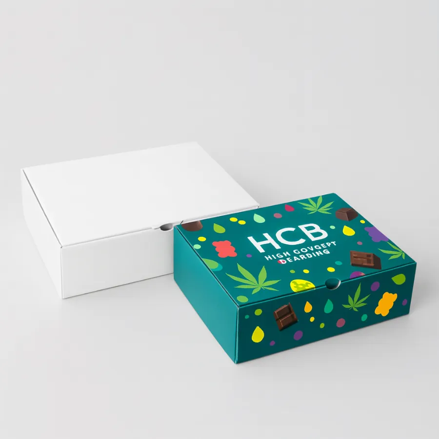Two apartment- square- elevator-off lid boxes for edibles packaging- one plain white and one with a colorful -HCB- logo and pattern- class=