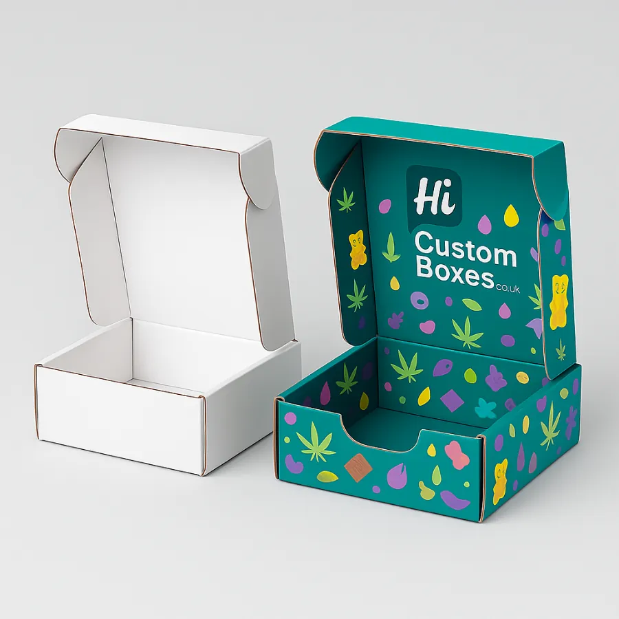 Two open mailer-style boxes for edibles packaging- one plain white and one fully printed with a colorful leaf and candy pattern- class=