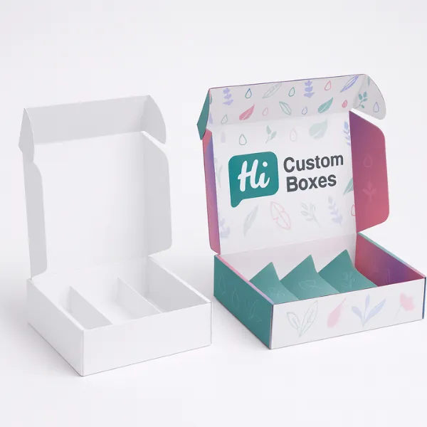 Two tall corrugated cardboard shipping boxes with open top flaps- one plain white and one with colorful Hi HCB printed branding- class=