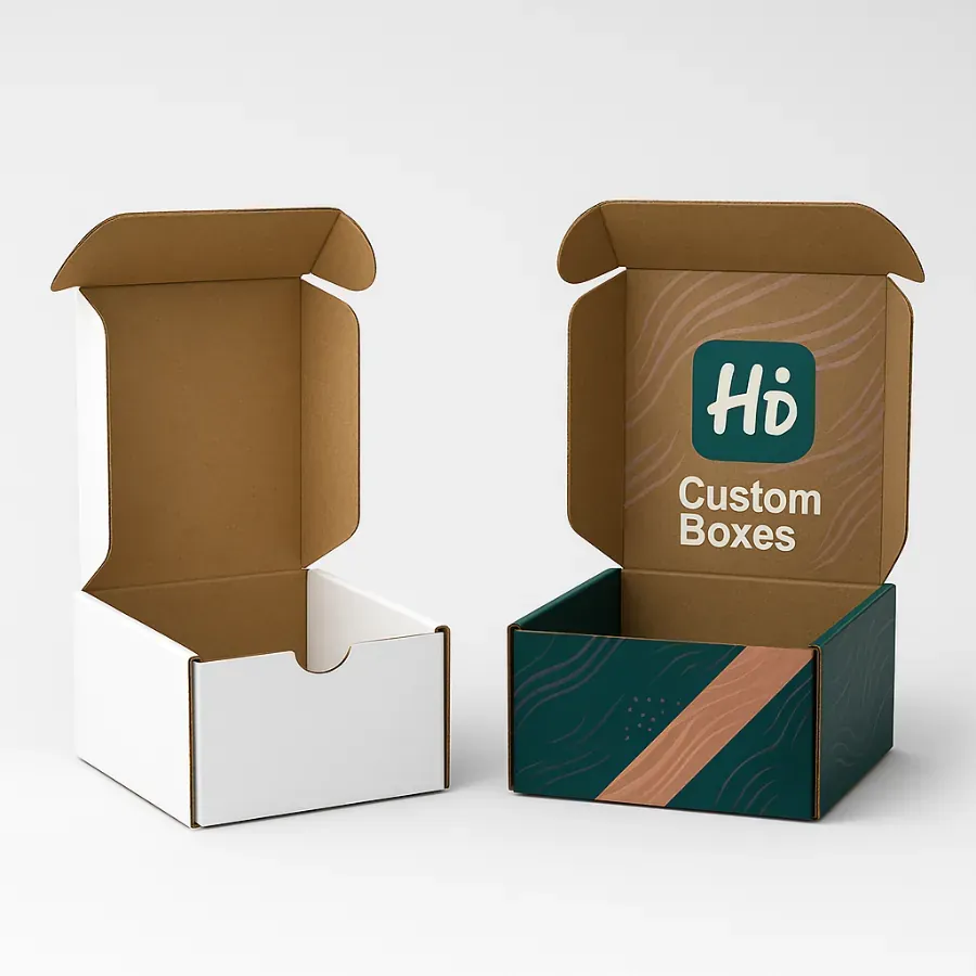 Mailer style cardboard packaging boxes with foldable flaps- One plain white box and one printed with Hi Custom Boxes branding in teal and copper with wave accents class=