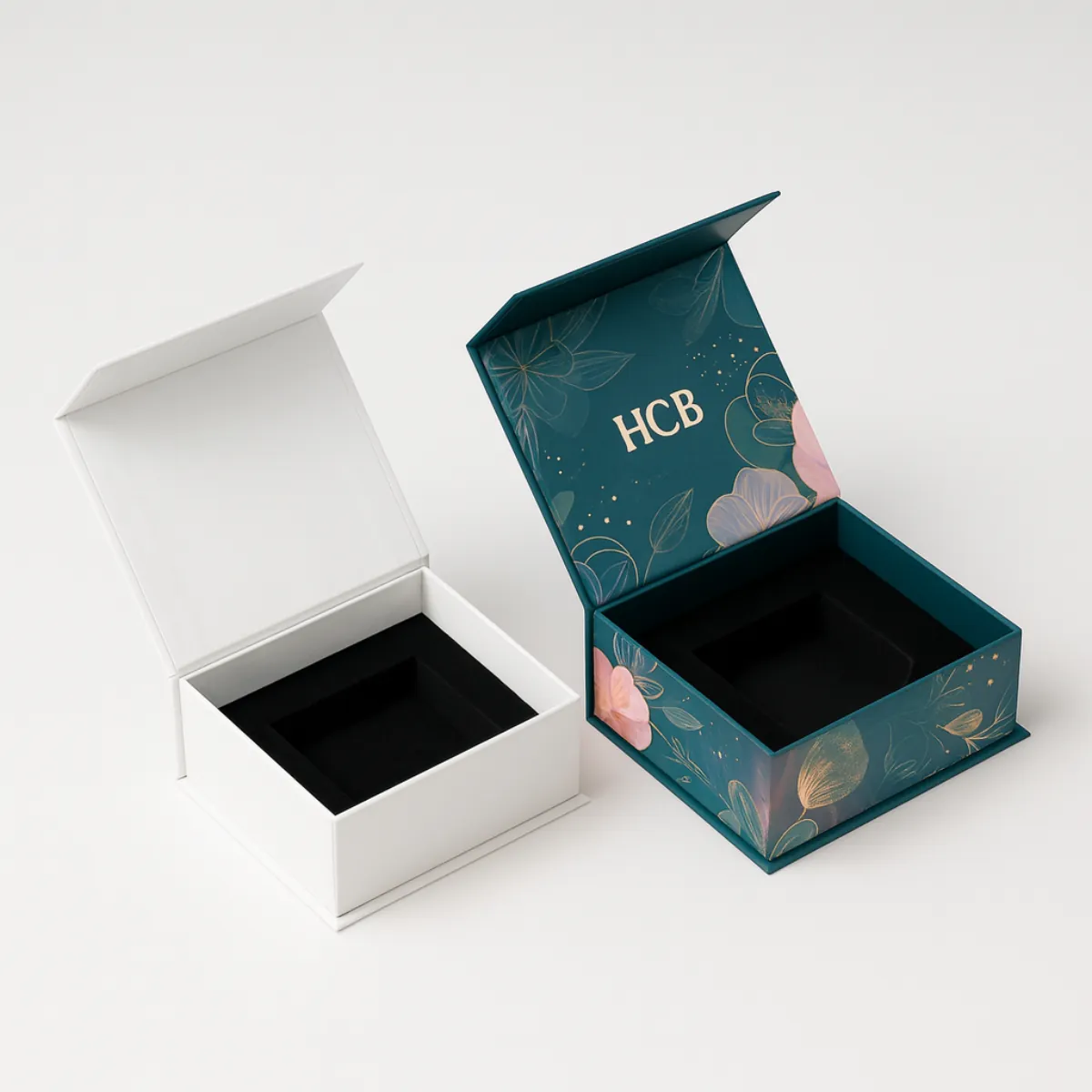 Two open luxury boxes- left is plain white- right is pink with floral design and -HCB- logo- class=
