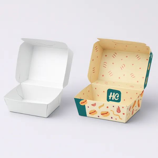 Open clamshell-style food box mockups- one plain white and the other printed with colorful fast-food graphics and HC logo branding-
