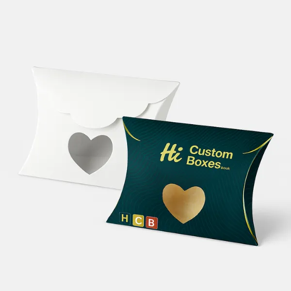 Heart-cut window pillow boxes - one plain white- one dark green with gold heart motif and HCB branding- class=