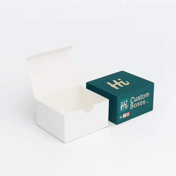 Two packaging boxes one plain white open tuck top box and one closed dark green branded box with logo class=