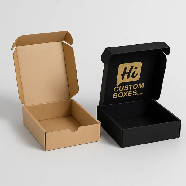 Mailing-style boxes - one kraft- one black with gold Hi Custom Boxes branding on the lid- class=