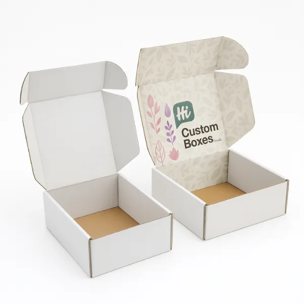 Mailer-style custom packaging boxes with floral interior print and -Hi Custom Boxes- branding- placed beside a plain white open mailer box- class=