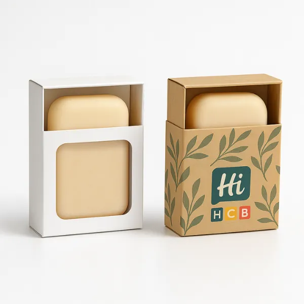 Two rectangular soap boxes with front windows - one plain white- one kraft with leafy Hi HCB branding- class=