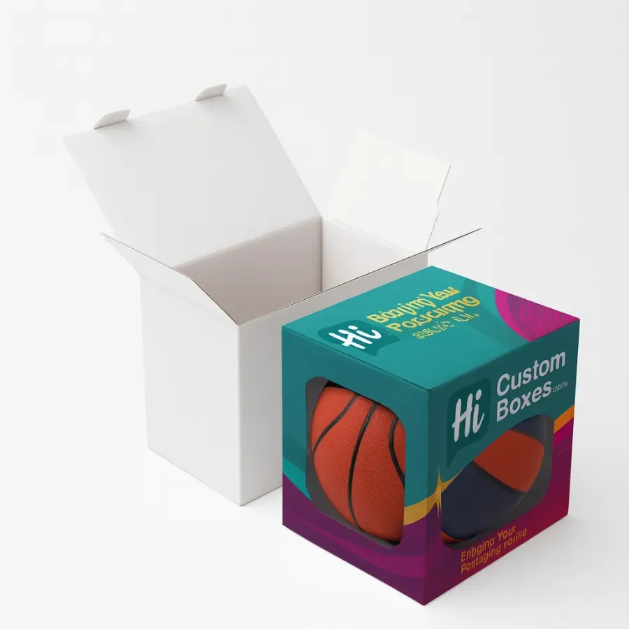 Custom retail packaging box with a clear window- designed for showcasing products like basketballs- next to a standard white shipping box class=