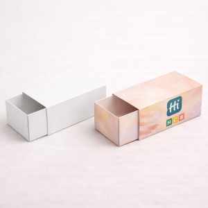 Two tall rectangular product boxes, one blank white and one printed with custom purple graphics.
