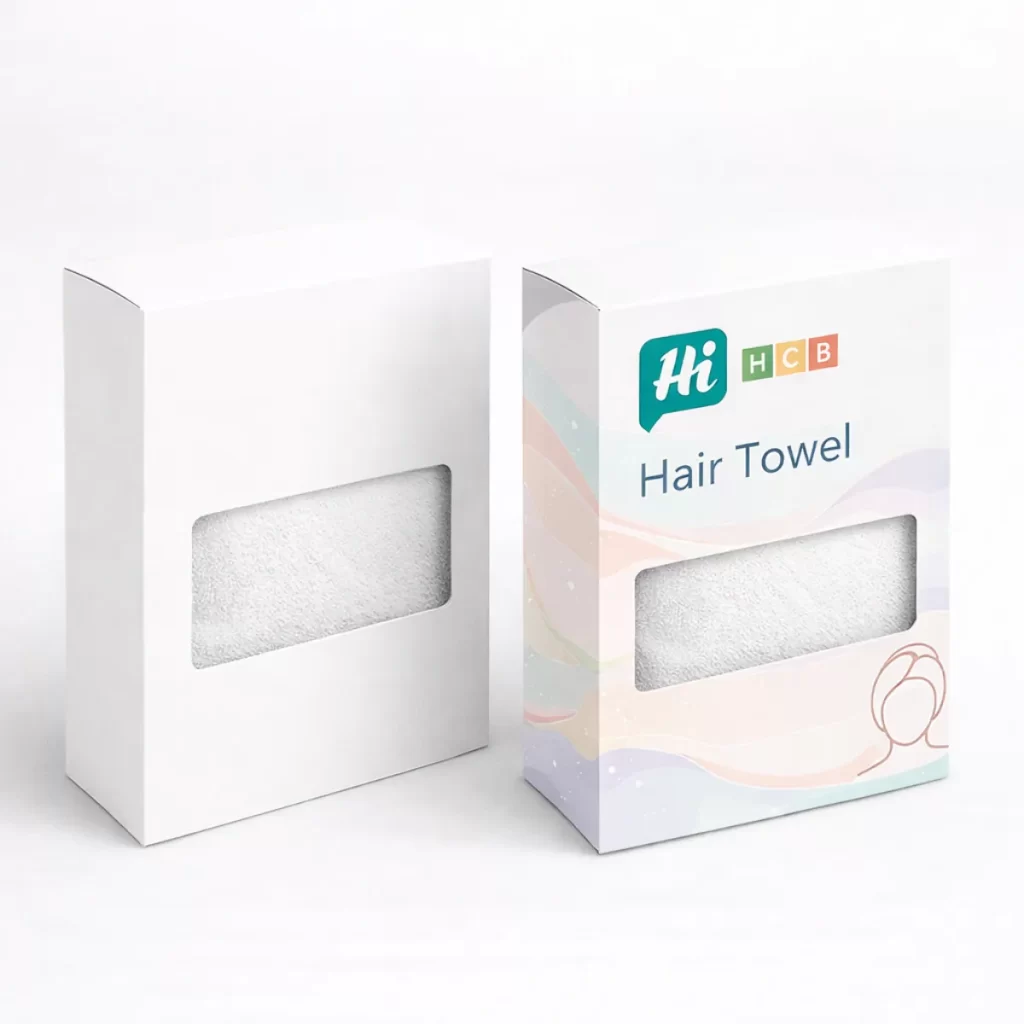 Two upright white boxes with rectangular cut-out windows showing the texture of a white hair towel.