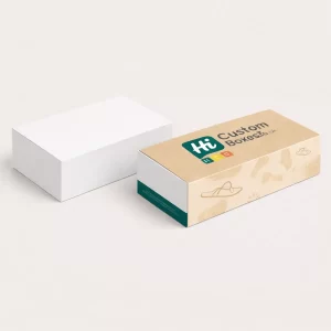 A minimalist white footwear box alongside a custom-printed beige box featuring illustrated sandal patterns.