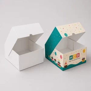 Two large square cardboard boxes, one plain white and one with colourful birthday party designs.