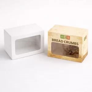 Two rectangular cardboard boxes with large transparent windows, one plain white and one with breadcrumb branding.