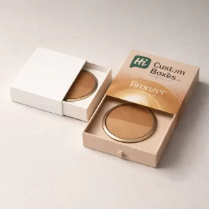 Two elegant sliding drawer boxes, one white and one branded, revealing a dual-tone bronzer compact.