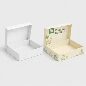 Two open mailing boxes, one natural brown Kraft and one with custom printed green leaf designs.