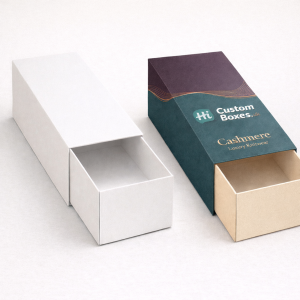 Two elegant sliding drawer boxes; one solid white and one branded teal with a cream-coloured inner tray.