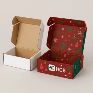 Two open shipping boxes, one plain and one custom-printed red with a Christmas pattern inside.