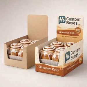 Two open-front counter display boxes showcasing large, gooey cinnamon rolls, designed for retail point-of-sale presentation.