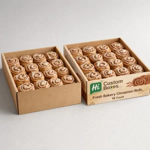 Two large cardboard trays packed with eighteen freshly baked cinnamon rolls, branded with "Fresh Bakery" and logos.