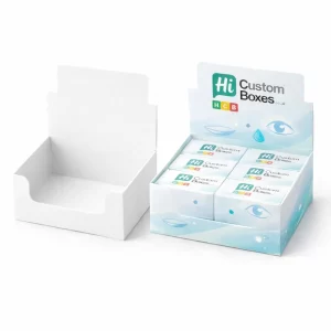 Display Boxes.jpg Cardboard counter display units, one blank and one filled with small branded contact lens boxes in blue.