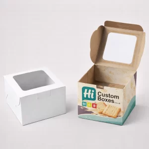 Cardboard cracker boxes with top viewing windows, showcasing wheat-themed designs and a plain version.