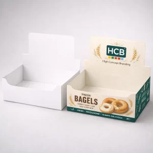 Two open cardboard mailer boxes, one natural kraft brown and one with a bright bagel pattern inside.
