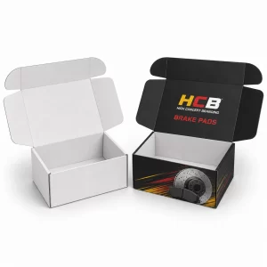 Two bespoke black and green brake pad boxes featuring professional logos and automotive part graphics.