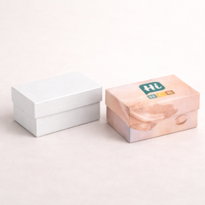 Two open cardboard mailer boxes, one plain brown and one featuring custom purple branding patterns.