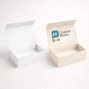 Two open magnetic-closure rigid boxes, one plain white and one with a sophisticated cream floral pattern.