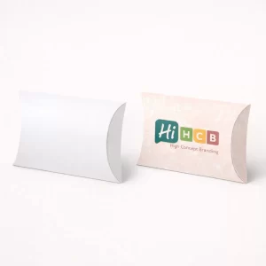 Elegant pillow-shaped gift boxes shown in a minimalist white and a floral pink branded design.