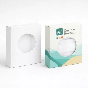 Two white rectangular retail boxes with hanging tabs, featuring a teal and sand-coloured wave design.