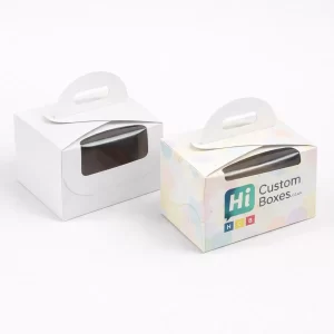 Two small white gabled boxes with windows and handles, one plain and one branded pastel.