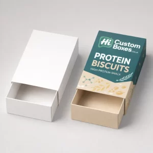 Two sleeve-style sliding drawer boxes, one plain white and one printed with teal protein biscuit designs.