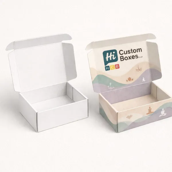 A pair of open cardboard boxes showing a clean white interior and a pastel-coloured exterior.