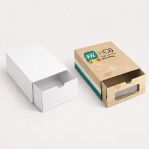 A white drawer-style box beside a branded beige pull-out sandal box with a transparent window.