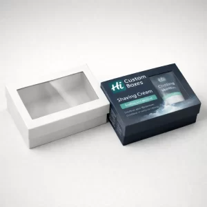 A white windowed box alongside a blue branded box with a clear window displaying the product inside.
