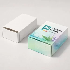 Two sliding drawer-style boxes, one plain white and one with lavender and water-wave botanical printed designs.