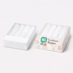 Two flat rectangular boxes with clear lids, each containing four neatly rolled white garments for display.