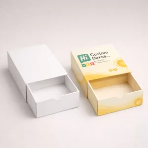 Two drawer-style slide boxes, one plain white and one featuring custom yellow and orange branding.