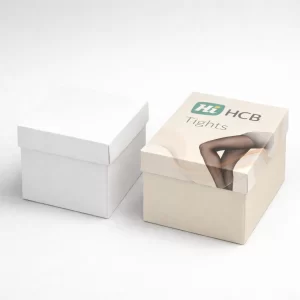 Two square lidded gift boxes for hosiery, one in plain white and one with branding.